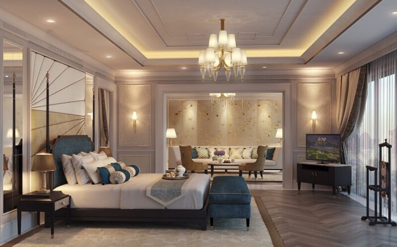 Phòng ngủ khách sạn có khu vực tiếp khách và làm việc riêng rộng rãi theo phong cách tân cổ điển